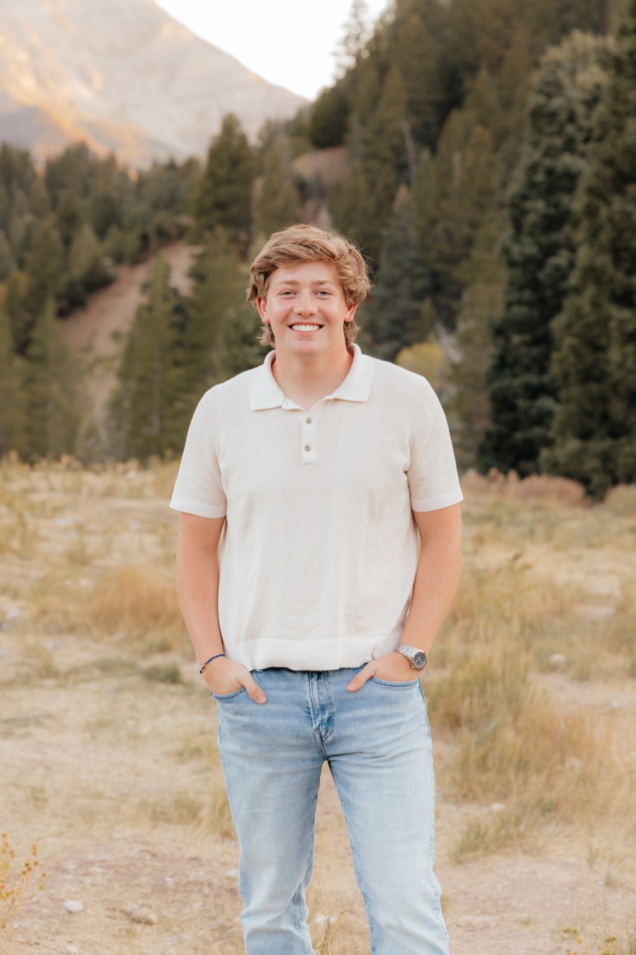 Luke Larsen, owner of Larsen Irrigation, standing in a mountain meadow in Utah County